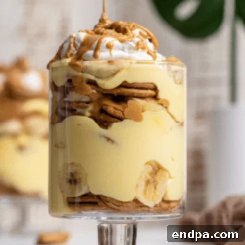 Peanut butter banana pudding with layers in a clear dish.