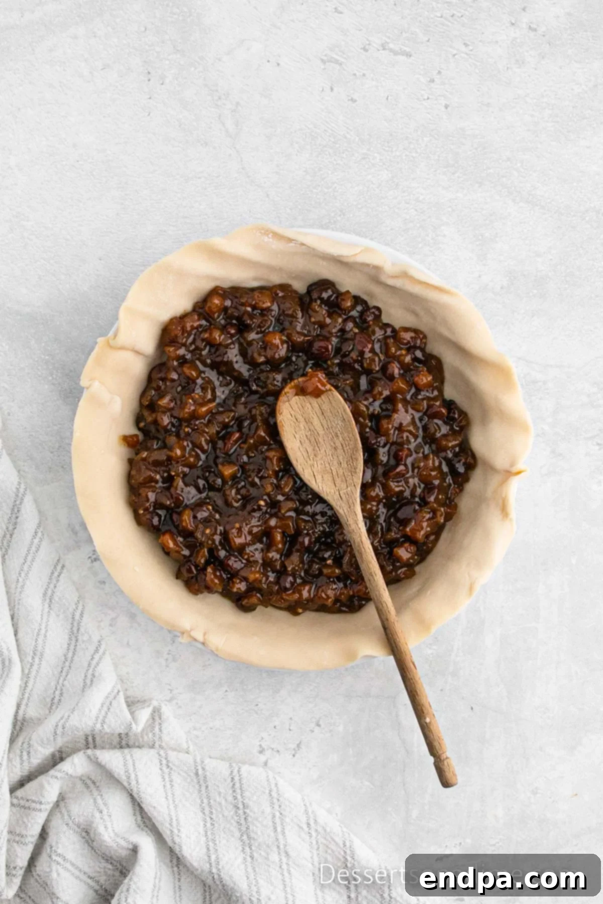 Traditional Christmas Mincemeat Pie 5 Spreading the mincemeat filling evenly into the prepared pie crust.
