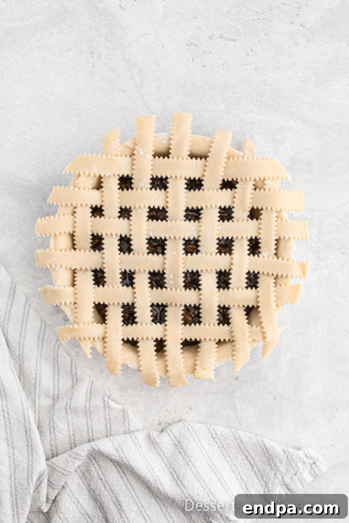 Traditional Christmas Mincemeat Pie 7 Weaving the pie crust strips over and under to form a beautiful lattice pattern on the pie.