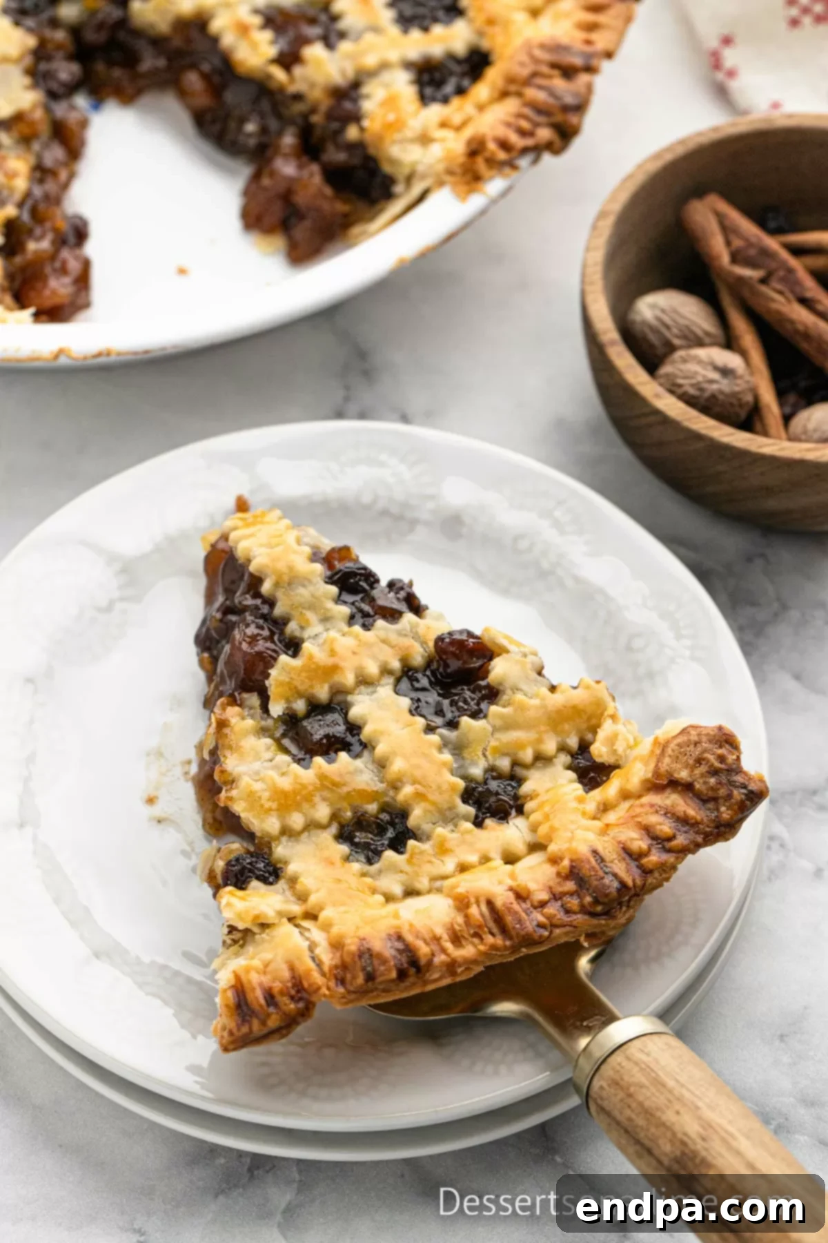 Traditional Christmas Mincemeat Pie 10 A perfect slice of mincemeat pie, showcasing the rich filling and flaky crust, served on a white plate.