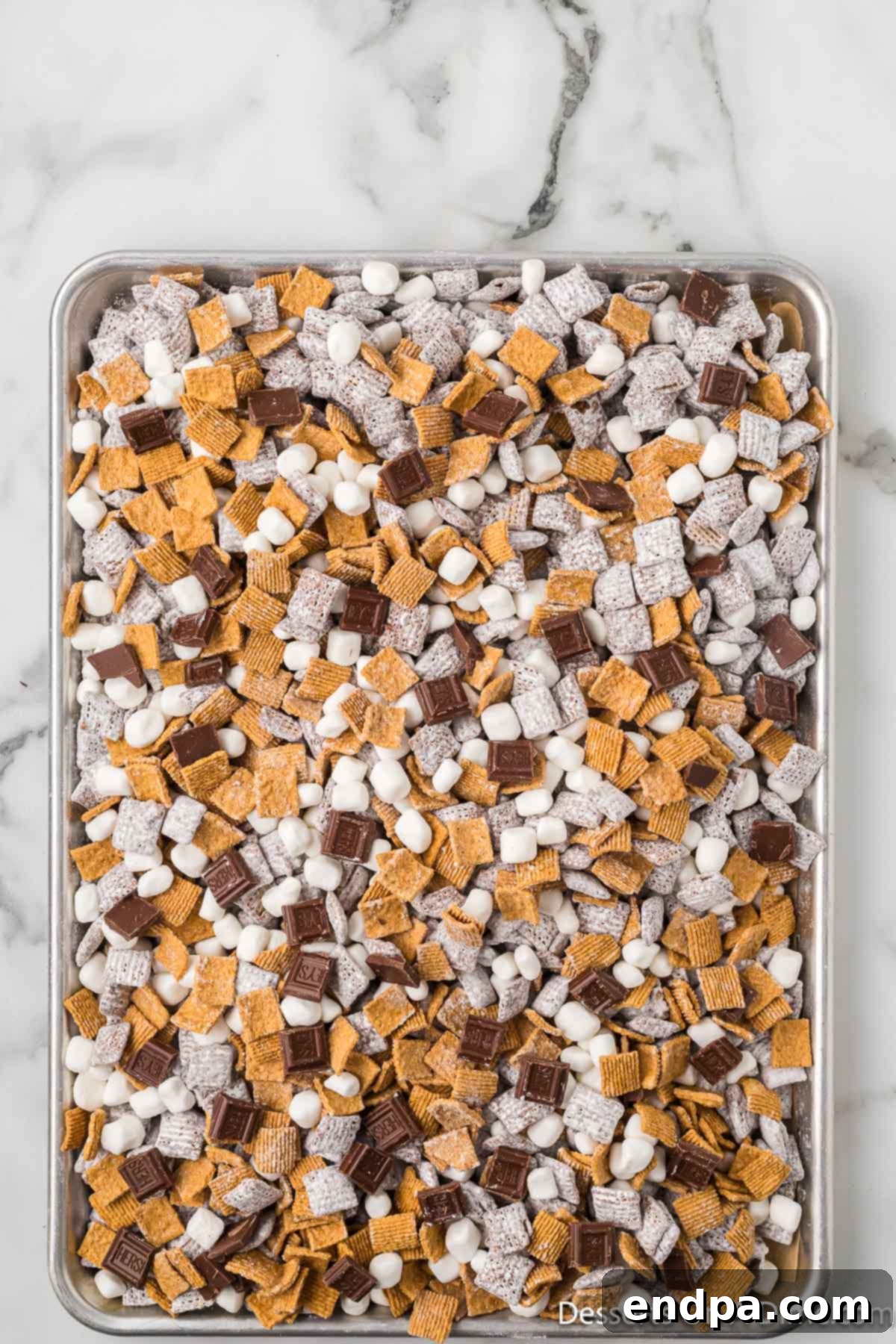Smores Indulgence Mix 11 Mini marshmallows and broken Hershey's chocolate pieces mixed into the S'mores Puppy Chow for the ultimate campfire treat.
