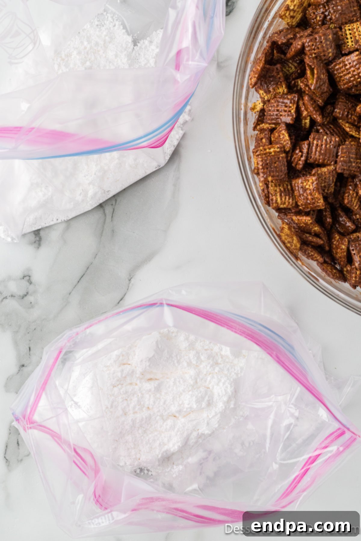 Smores Indulgence Mix 7 A gallon-sized ziplock bag partially filled with powdered sugar, ready for coating the cereal.
