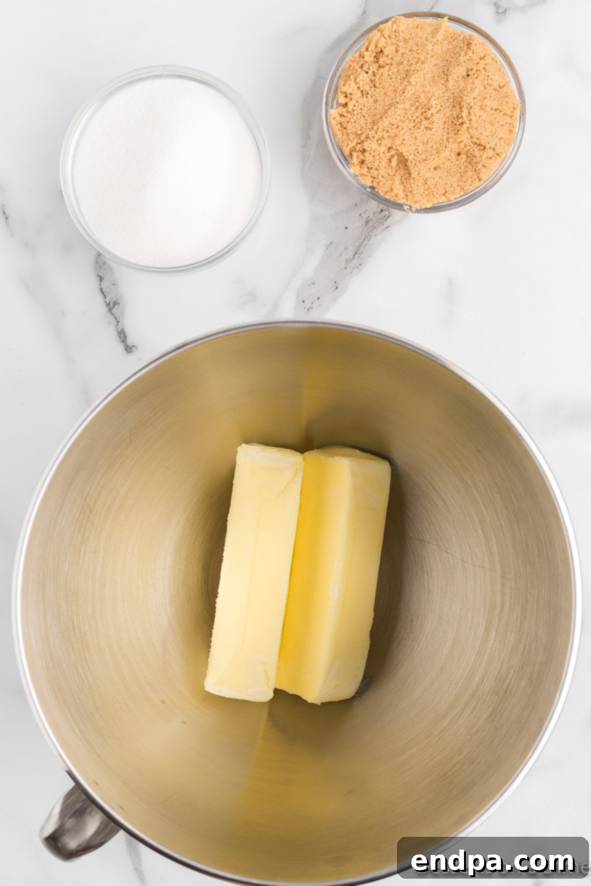 Festive Frontier Cookies 5 Beating softened butter and sugars (granulated and brown) together in a stand mixer bowl until light and fluffy.