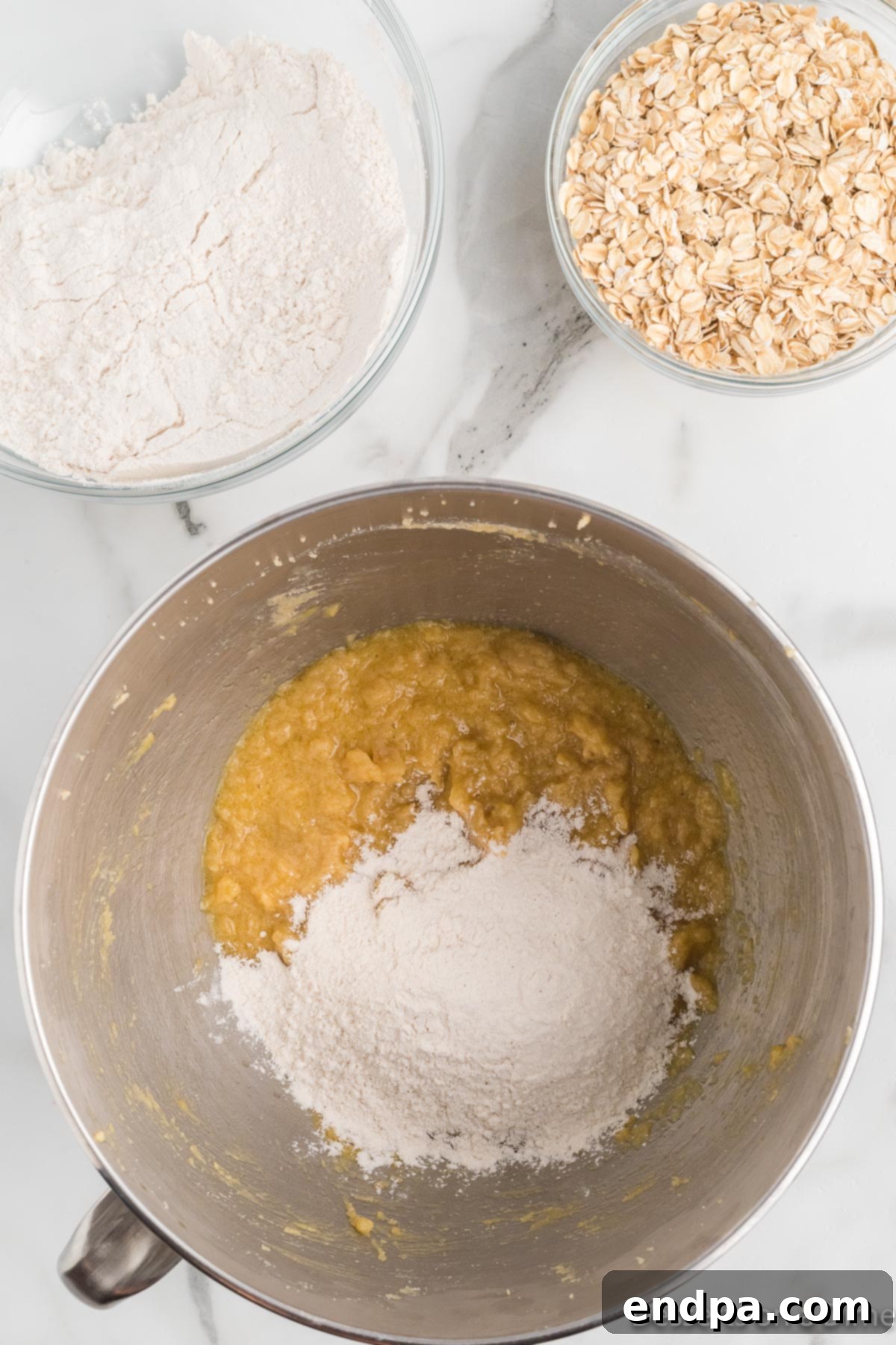 Festive Frontier Cookies 7 Gradually combining the whisked dry ingredients with the wet butter and sugar mixture using a mixer on low speed.