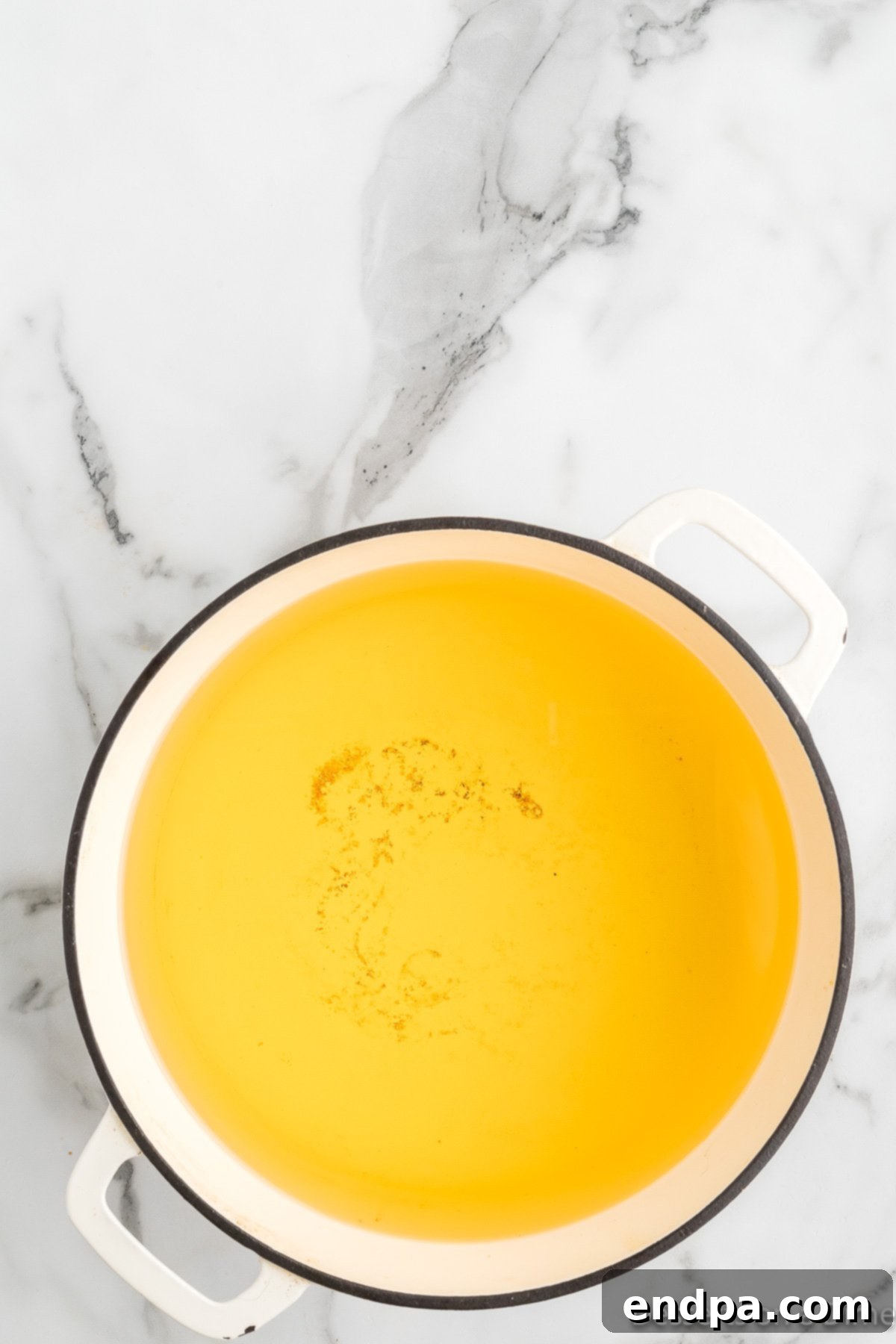 Vegetable oil heating in a deep pot on the stove.