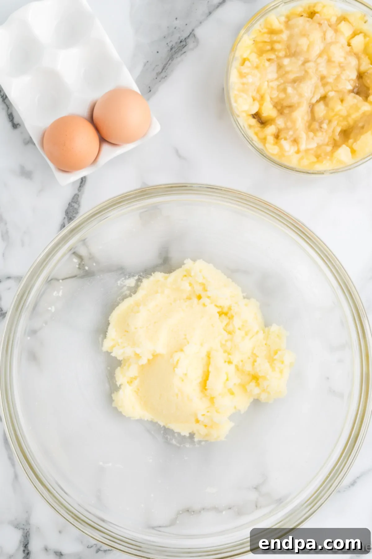 Butter and sugar combined in a bowl, after being creamed together.