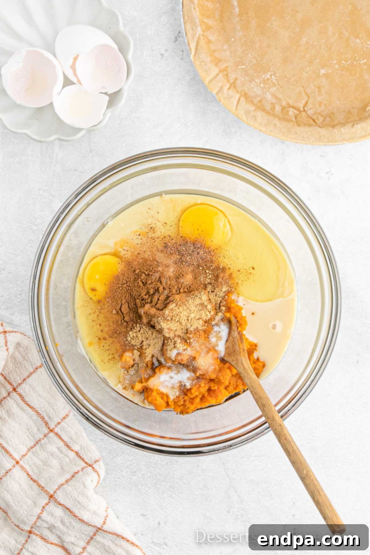 A bowl filled with all the combined pumpkin pie ingredients, mixed smoothly.