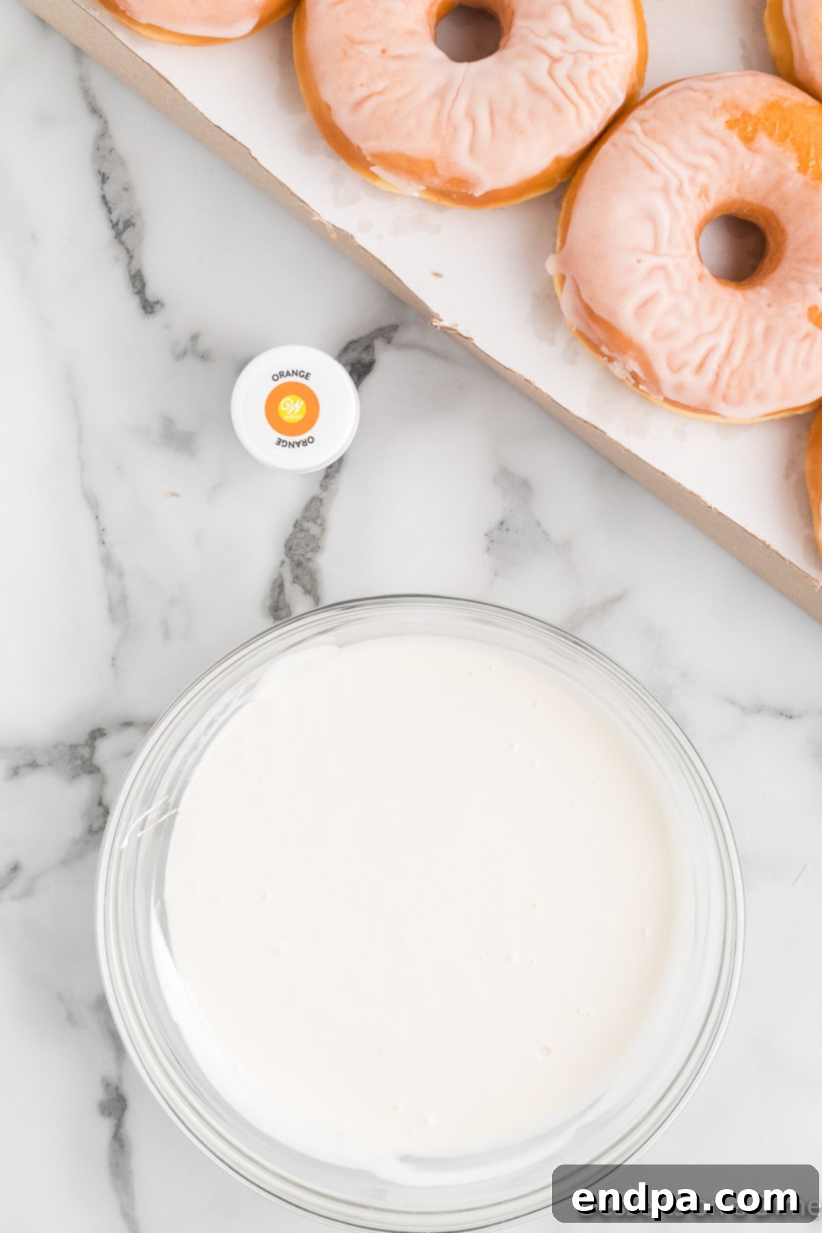 Spooky Delicious Halloween Donuts 4 White frosting being heated in a microwave-safe bowl.