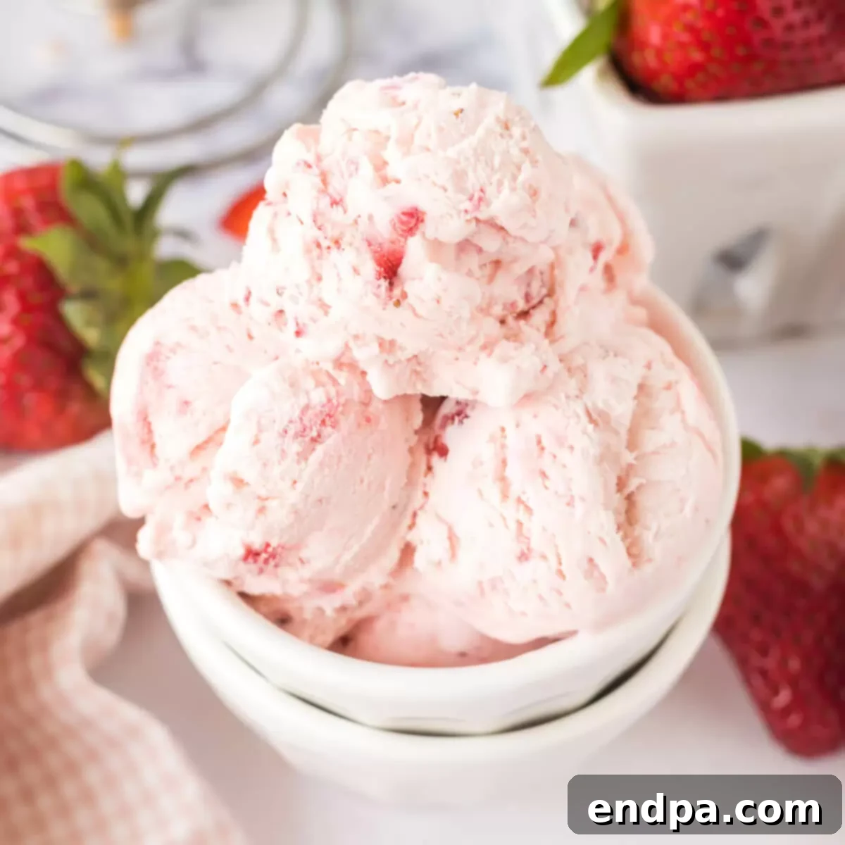 A large, appealing photo of freshly scooped No-Churn Strawberry Ice Cream in a bowl.