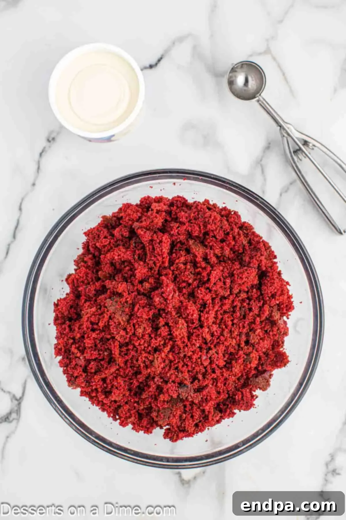 Grinchmas Cake Bites 4 Crumbled red velvet cake in a large mixing bowl, ready for frosting.