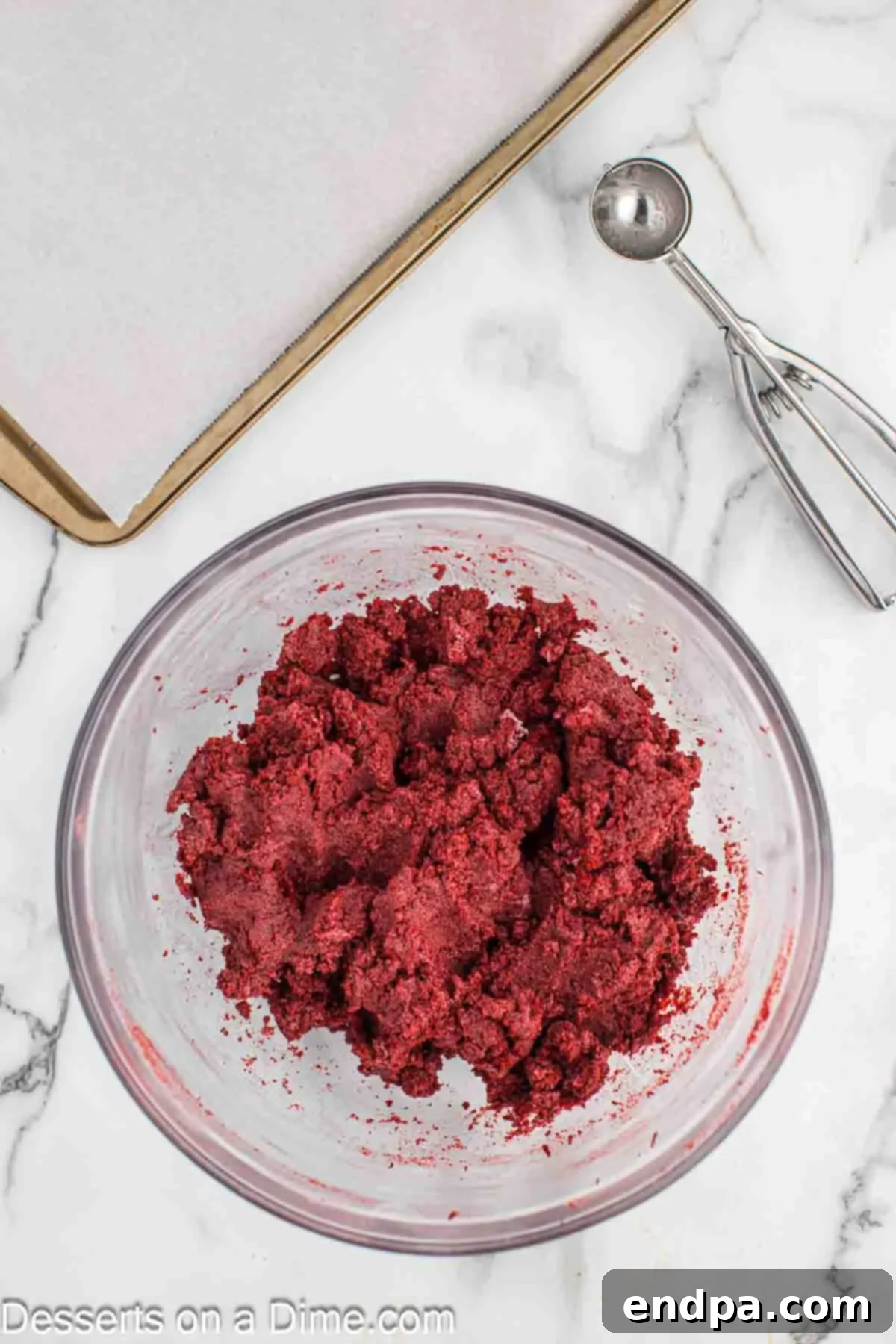 Grinchmas Cake Bites 5 Cake crumbs thoroughly combined with cream cheese frosting in a mixing bowl.