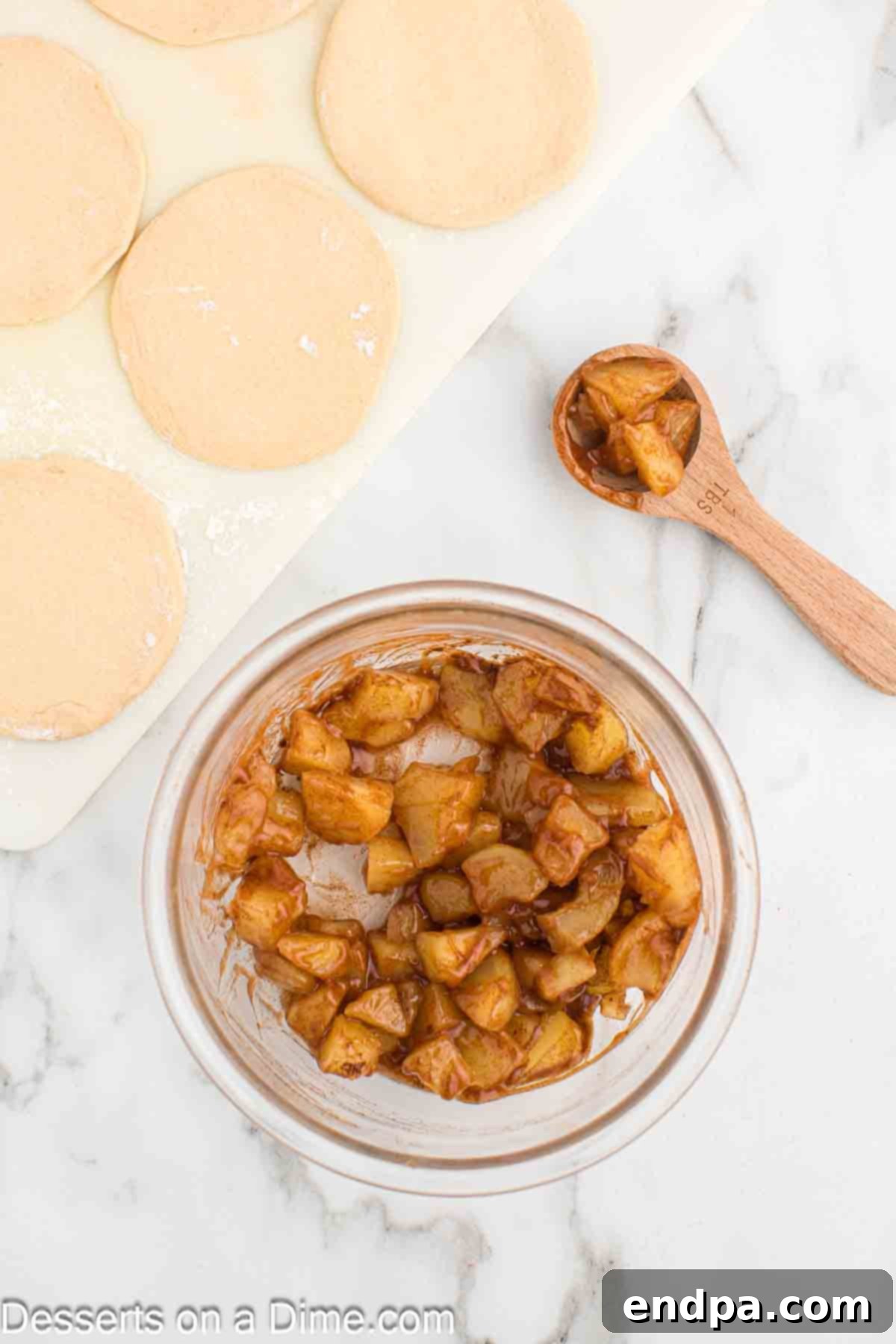 Air Fryer Apple Pie Bites 6 Canned apple pie filling in a bowl, with some pieces already chopped smaller.