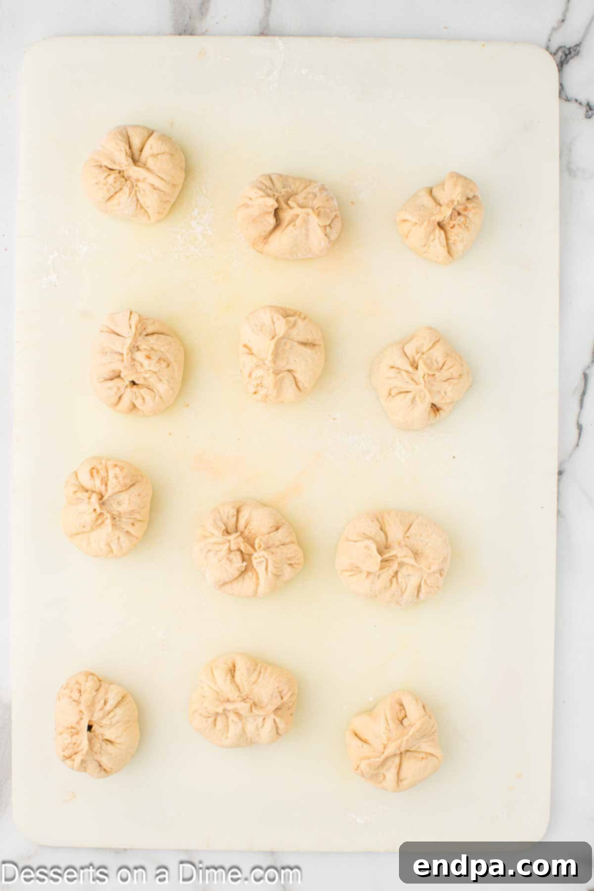 Air Fryer Apple Pie Bites 8 Dough circles with filling, pinched together at the top to seal the filling inside.