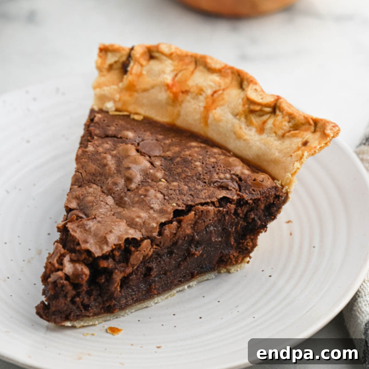 Fudgy Brownie Pie with chocolate chips, served with ice cream.