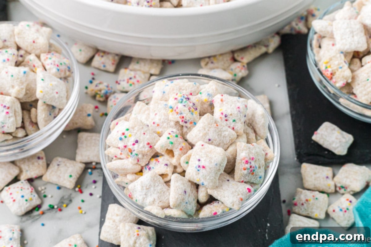 Festive Funfetti Snack Mix 11 A close-up shot of individual pieces of Funfetti Puppy Chow, showing the intricate coating of cake mix and sprinkles