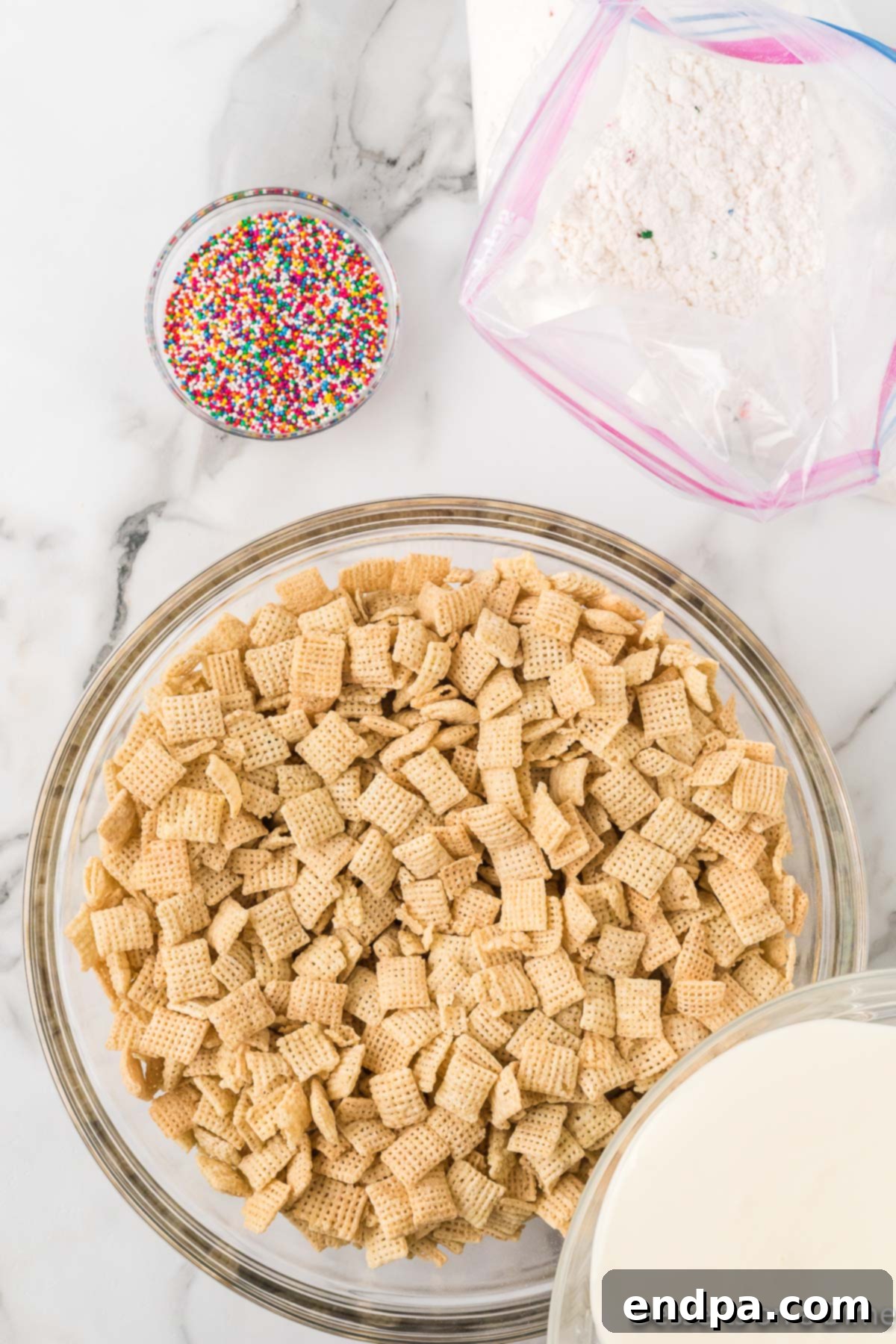 Festive Funfetti Snack Mix 5 Crispy Rice Chex cereal neatly arranged in a spacious mixing bowl