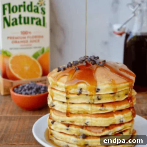 Orange Ricotta Chocolate Chip Pancakes with orange slices and chocolate chips.
