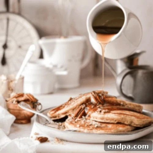 Butter Pecan Pancakes drizzled with bourbon sauce and sprinkled with pecans.