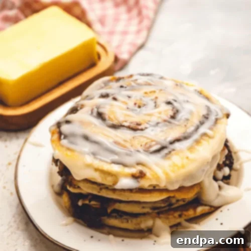Cinnamon Roll Pancakes with cream cheese glaze and cinnamon swirl.