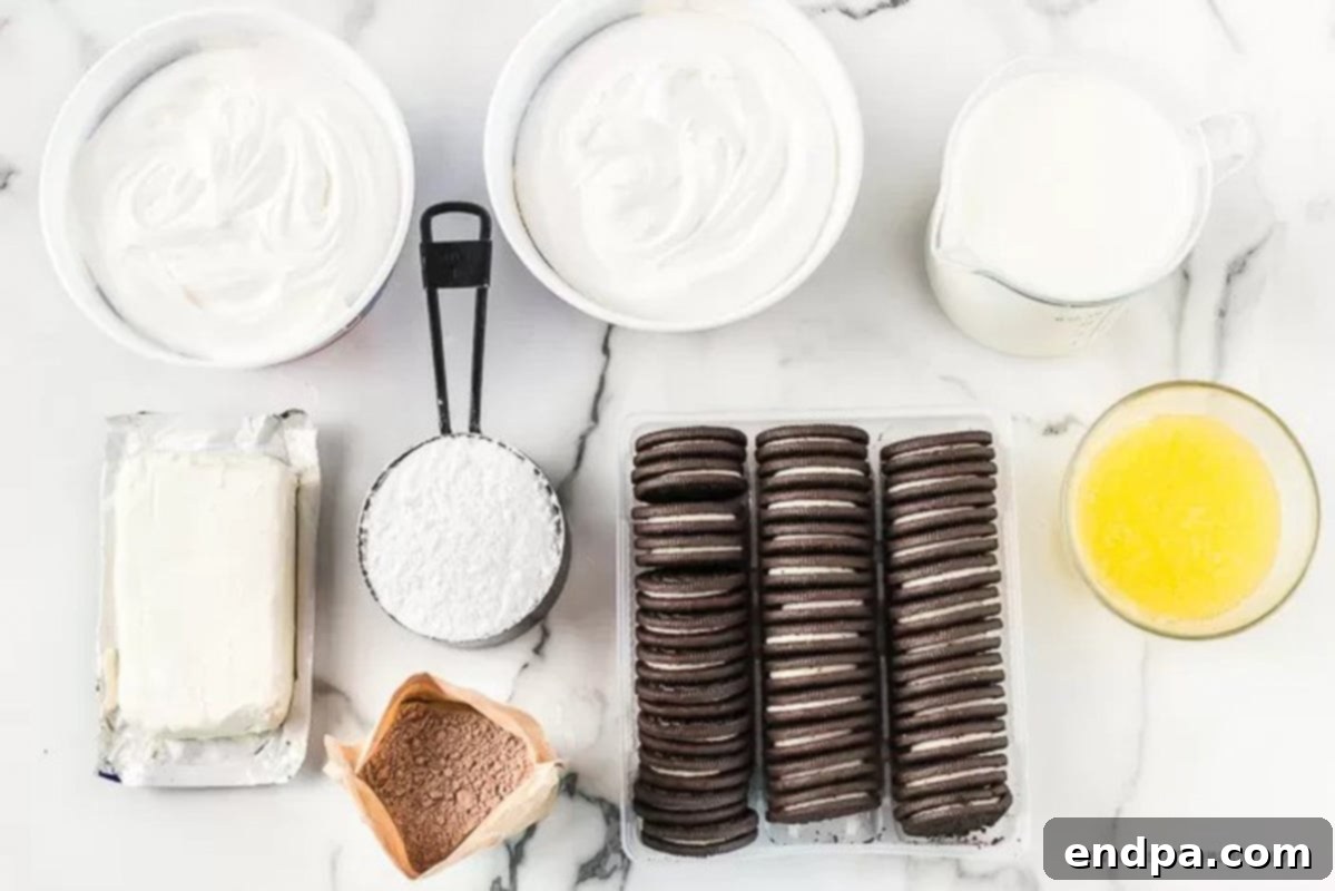 A flat lay image showing all the ingredients needed for Oreo Lasagna: a package of Oreos, a stick of butter, a block of cream cheese, powdered sugar, a tub of Cool Whip, a box of chocolate instant pudding, and a glass of milk.