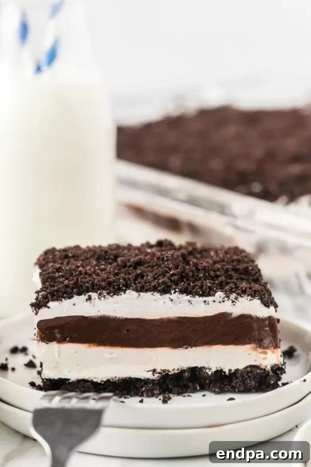 Another enticing view of a slice of Chocolate Oreo Lasagna on a plate, highlighting its rich layers and tempting texture.