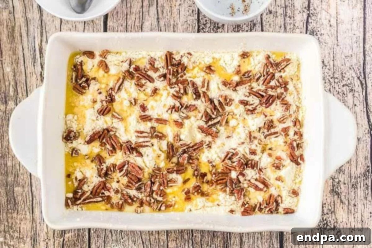 Cake Mix Layer on Pumpkin Cake Dry yellow cake mix spread evenly over the pumpkin batter in the baking pan, topped with melted butter and chopped pecans.