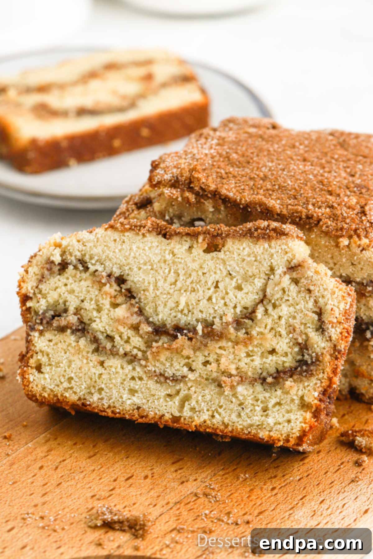 Delicious slices of snickerdoodle bread with visible cinnamon swirls, ready to be enjoyed as a sweet treat.