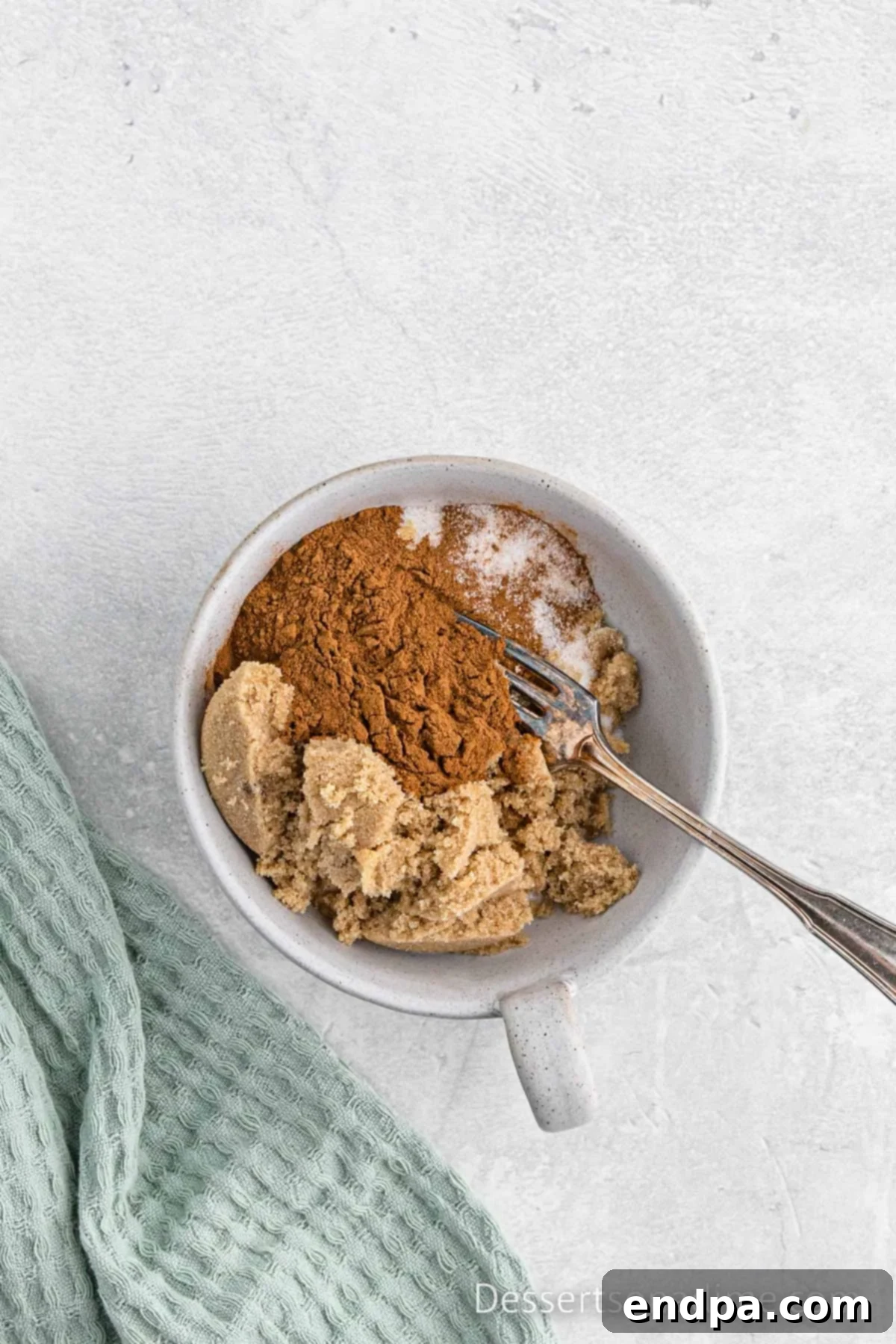 Small bowl containing the cinnamon sugar swirl mixture, ready to be layered into the bread batter.