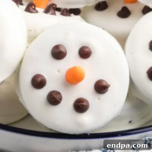 Simple Oreo Snowman Cookies decorated with icing