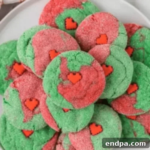 Green and red Grinch Cake Mix Cookies with a heart candy