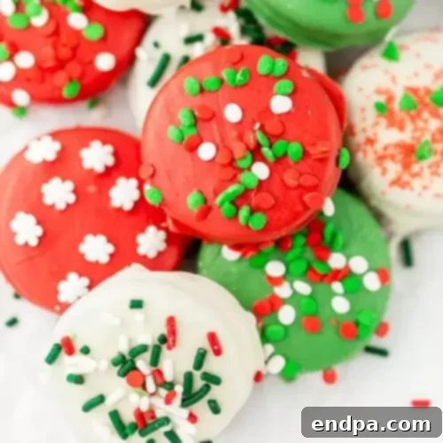 Oreo cookies covered in chocolate and Christmas sprinkles