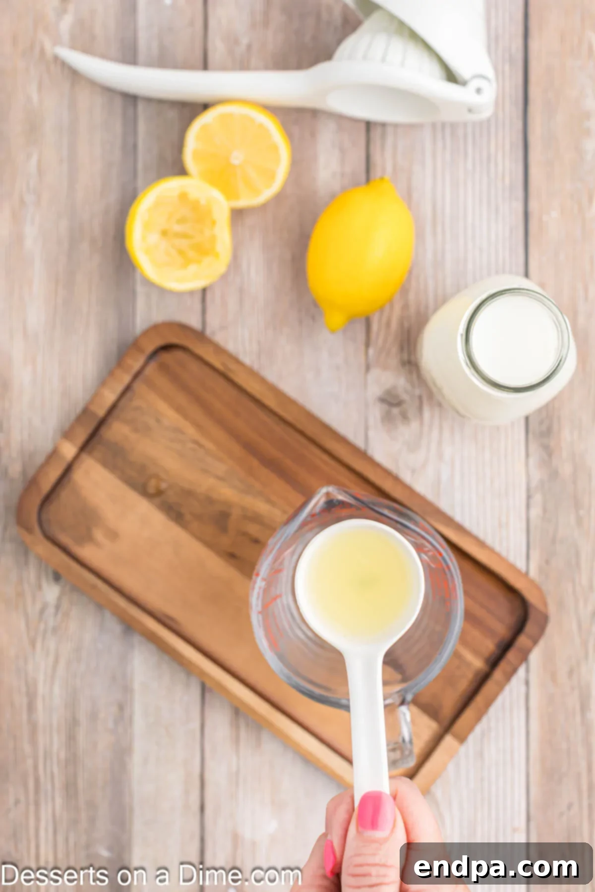 Lemon juice poured into measuring cup. 