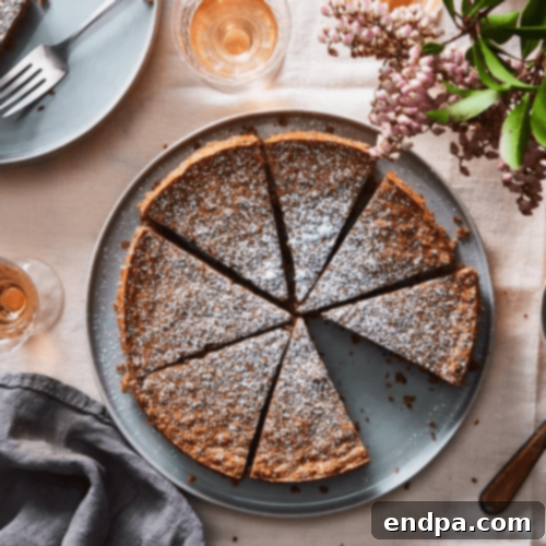Slice of Flourless Pecan Cake with powdered sugar on a plate.
