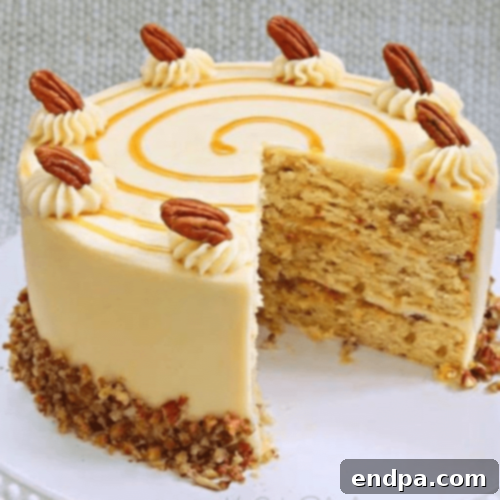 Slice of Toffee Pecan Caramel Cake with Caramel Cream Cheese Frosting on a plate.
