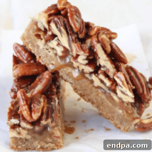 Brown Butter-Maple-Pecan Blondies in a baking pan, sliced.