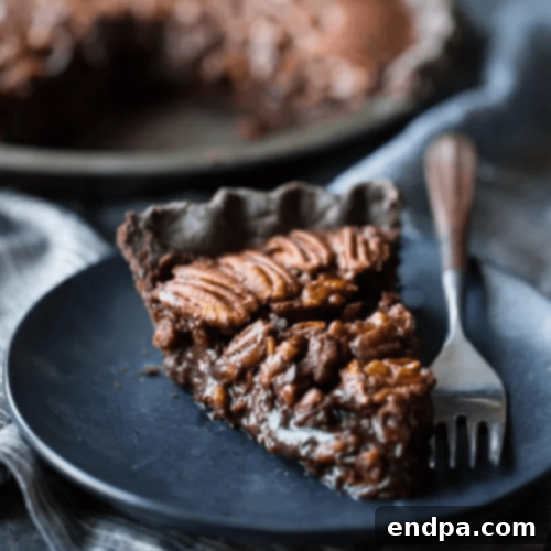 Slice of Double Chocolate Pecan Pie on a plate.