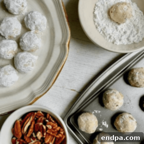 Pecan Snowball Cookies dusted with powdered sugar.
