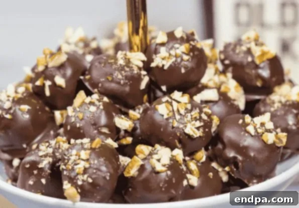 Sweet Pecan Bourbon Balls coated in powdered sugar.