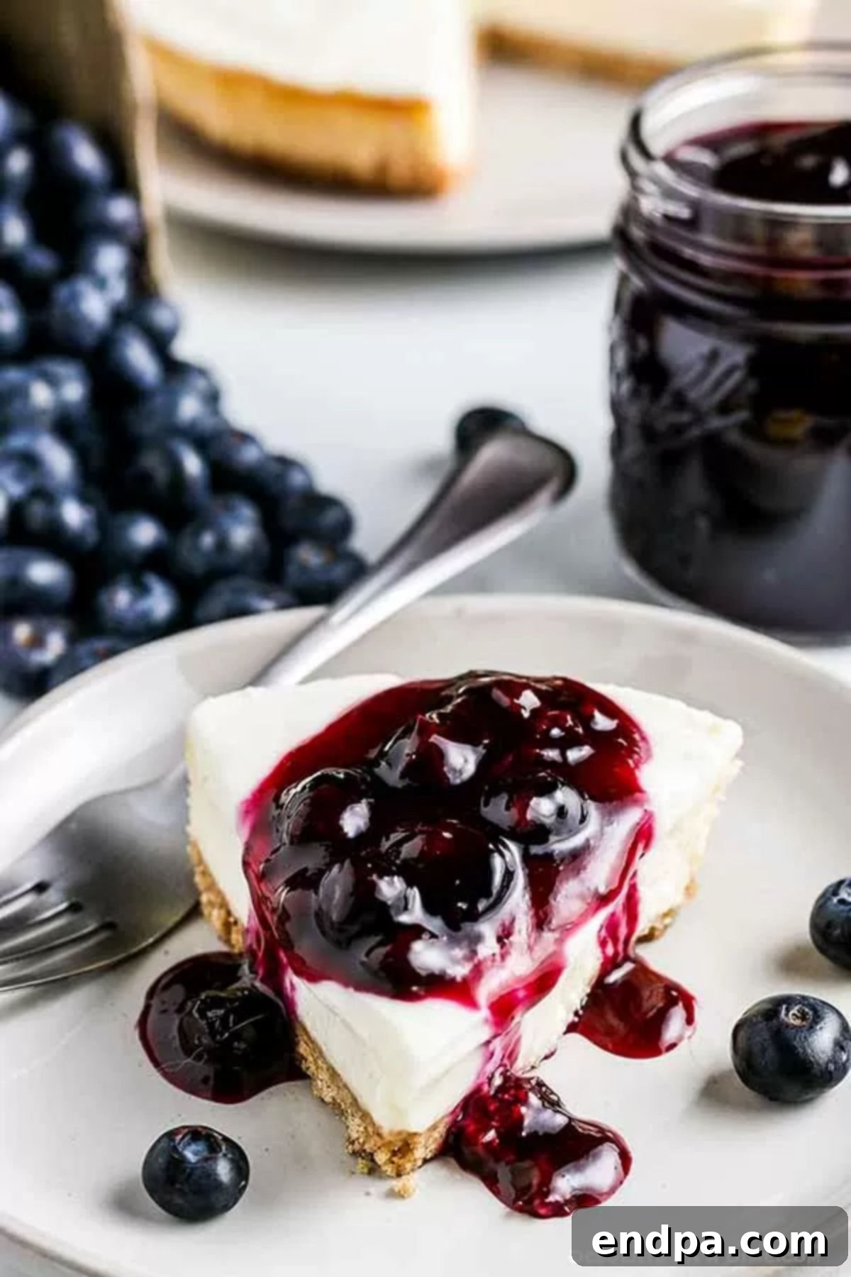 Blueberry sauce drizzled over a slice of cheesecake