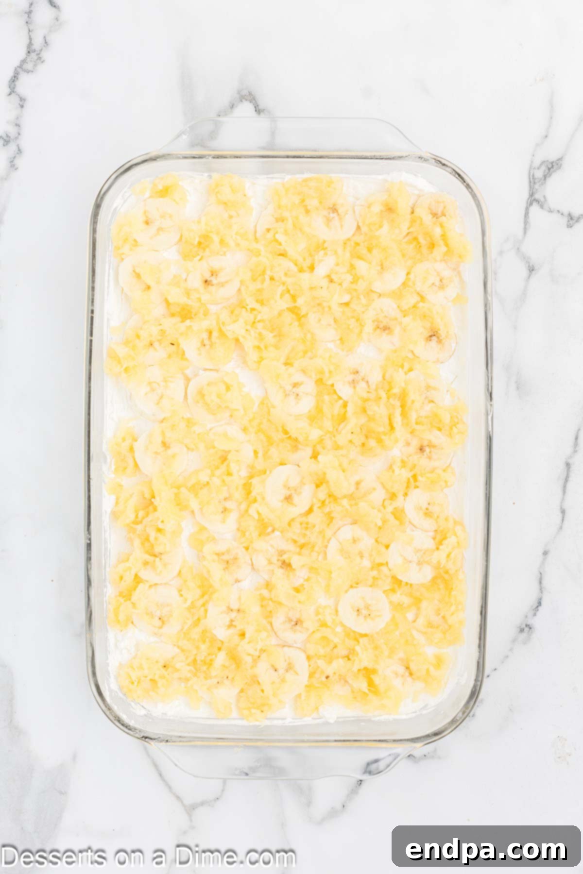 Banana Split Dream Cake 5 Finely crushed pineapple, meticulously drained, sprinkled evenly over the banana layer in the baking pan.