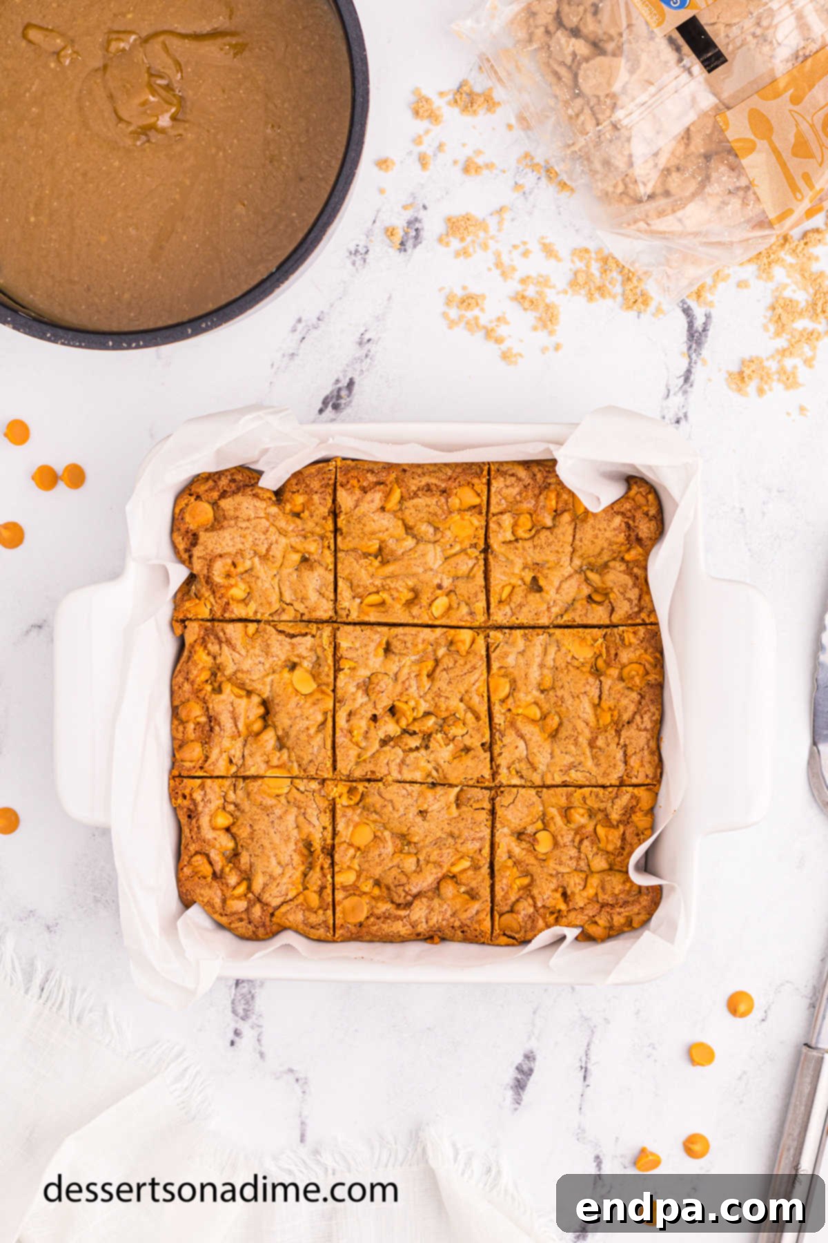Maple Caramel Blondie Bars 13 Blondies cut into bars in a pan and topped with glaze.