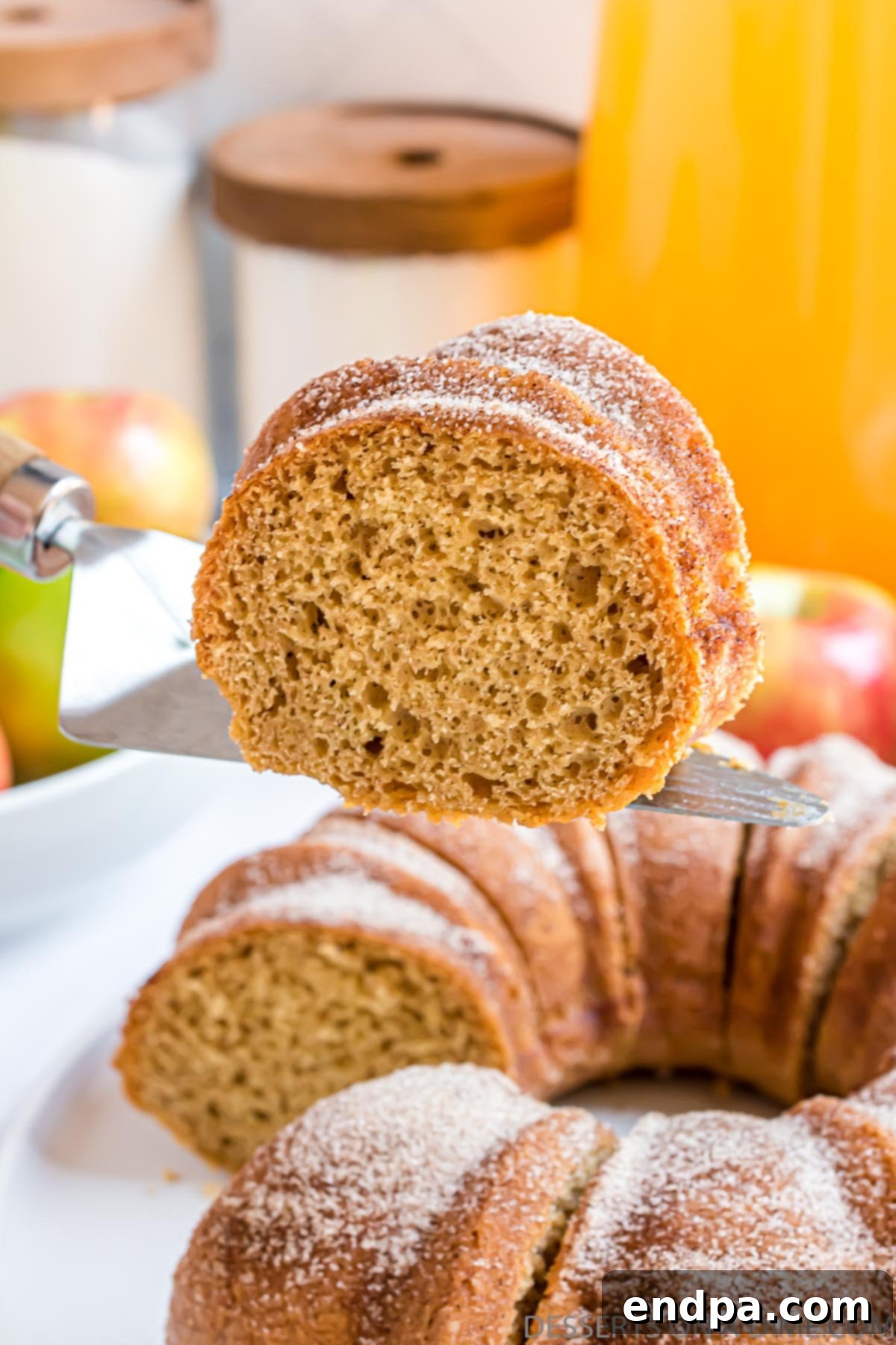 Autumn Apple Cider Bundt 2 Apple cider bundt cake being sliced.