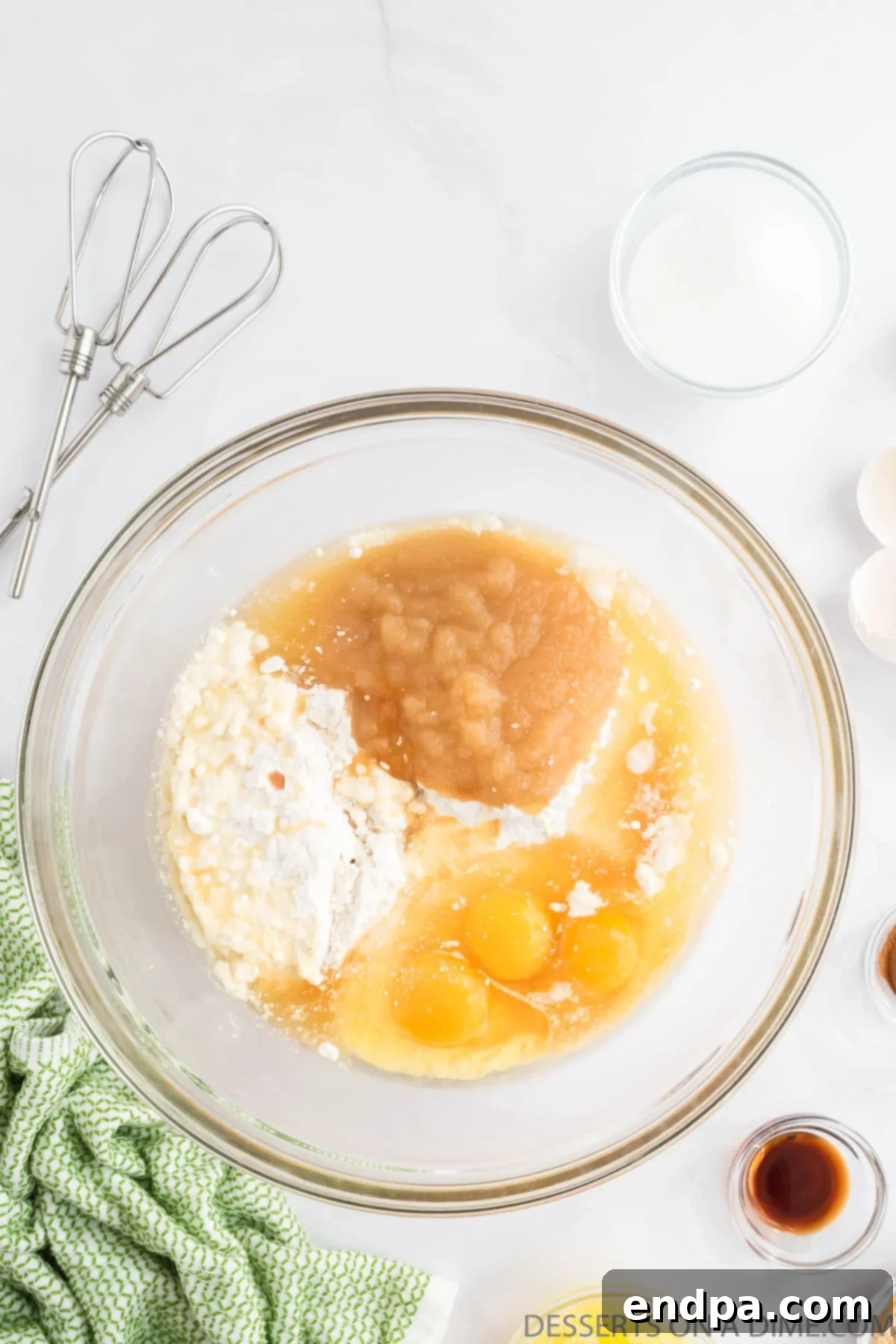 Autumn Apple Cider Bundt 4 Mixing bowl with cake mix, apple cider and applesauce.