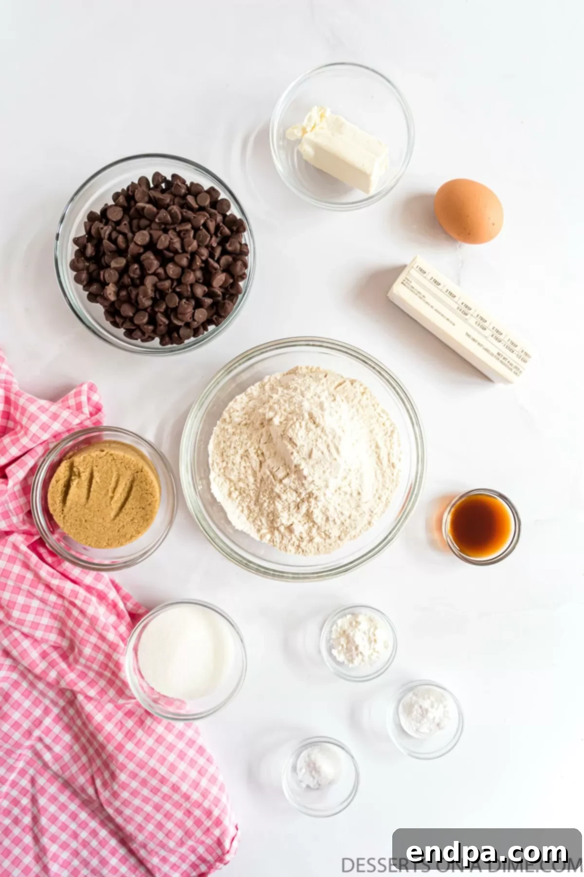 Ingredients for making cream cheese chocolate chip cookies: butter, cream cheese, brown sugar, granulated sugar, egg, vanilla extract, all-purpose flour, cornstarch, baking soda, salt, and semi-sweet chocolate chips.