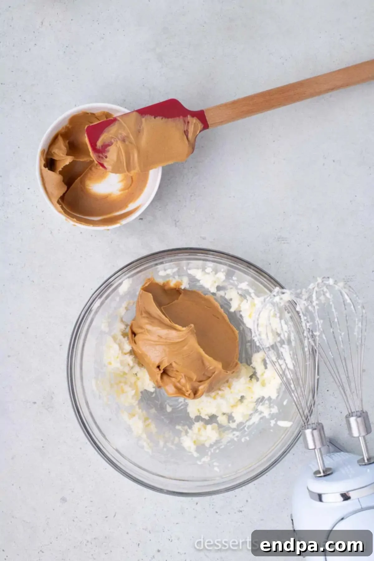 Buckeye Peanut Butter Delights 4 Powdered sugar and creamy peanut butter in a mixing bowl, ready to be combined.