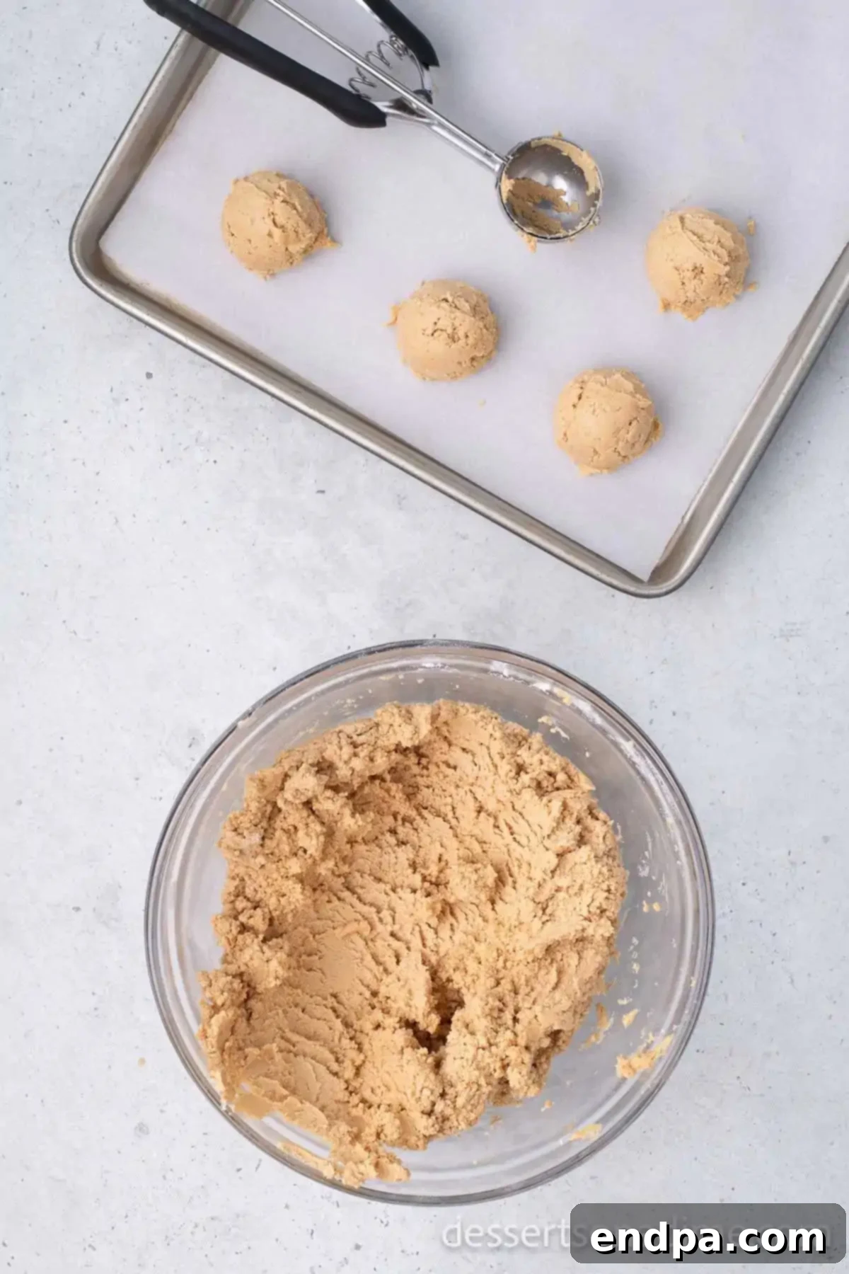 Buckeye Peanut Butter Delights 6 A small cookie scoop gently placing uniform peanut butter balls onto a baking sheet lined with wax paper.