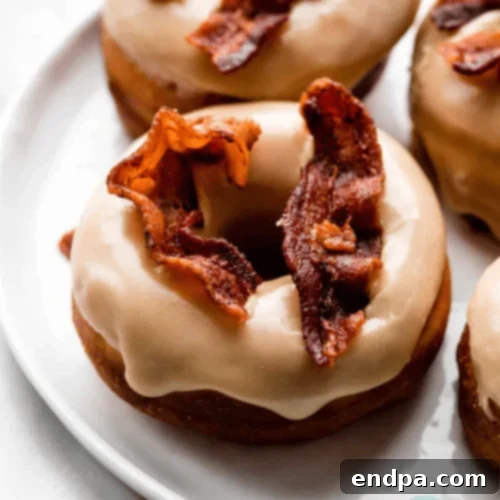 Maple Bacon Doughnuts topped with maple glaze and crispy bacon bits.