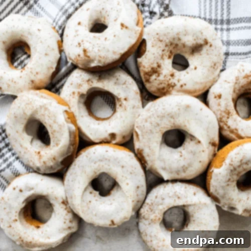 Gluten-Free Pumpkin Doughnuts with cream cheese glaze, a delicious fall treat.