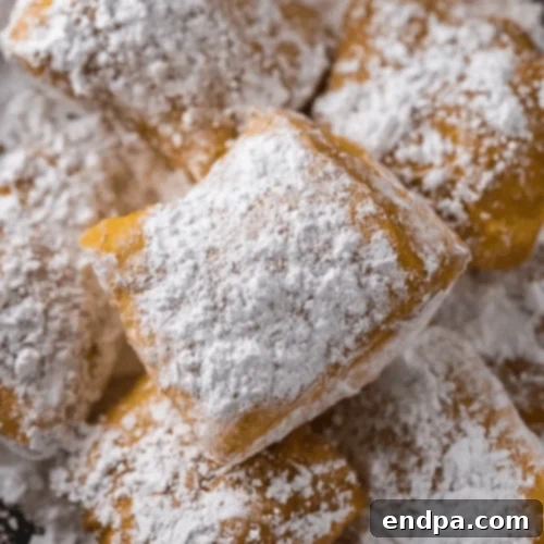 New Orleans Style Beignets generously dusted with powdered sugar.