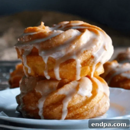 French Cruller Doughnuts with a glossy honey glaze, elegantly presented.